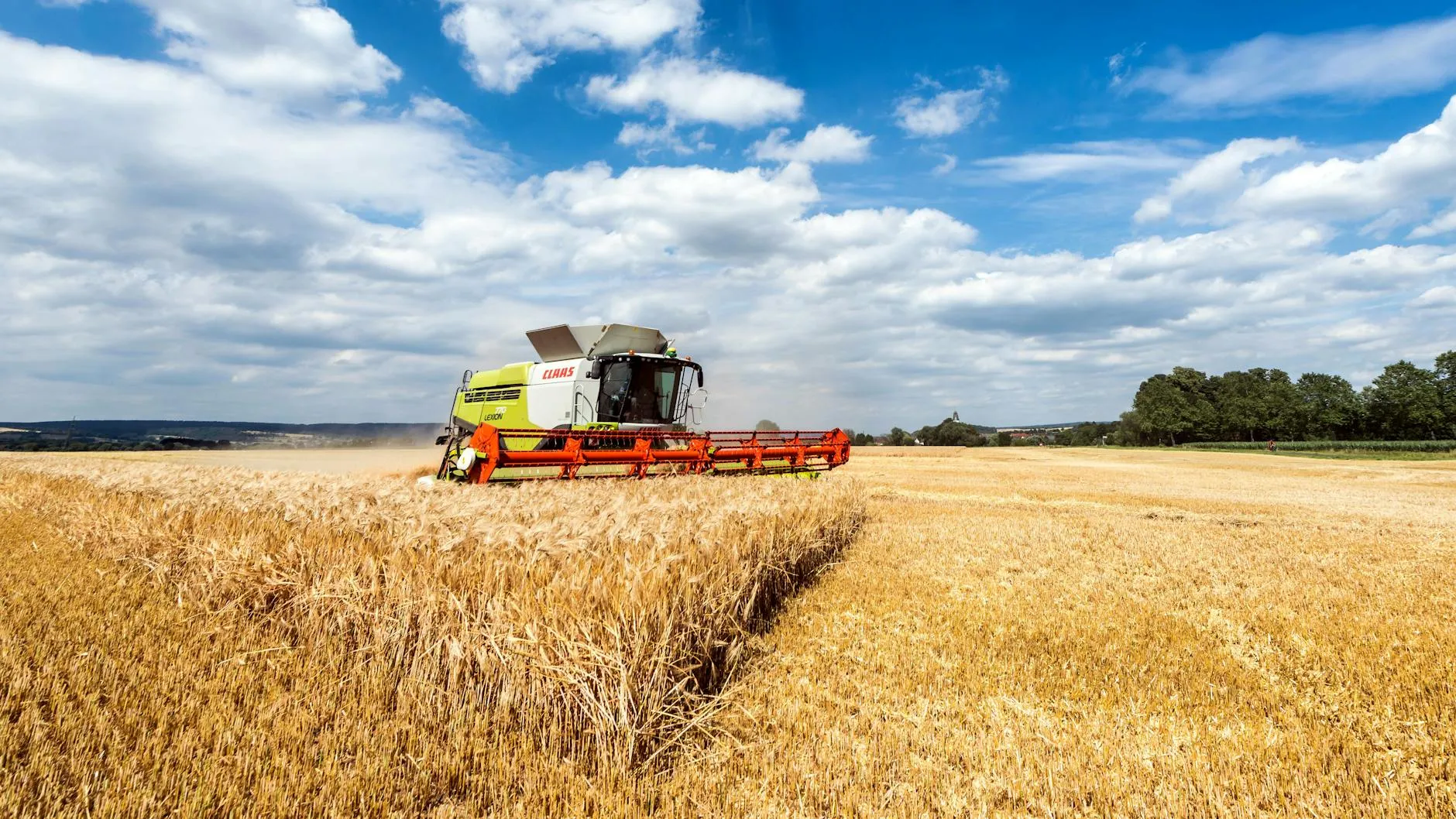 robotický traktor na poli při západu slunce